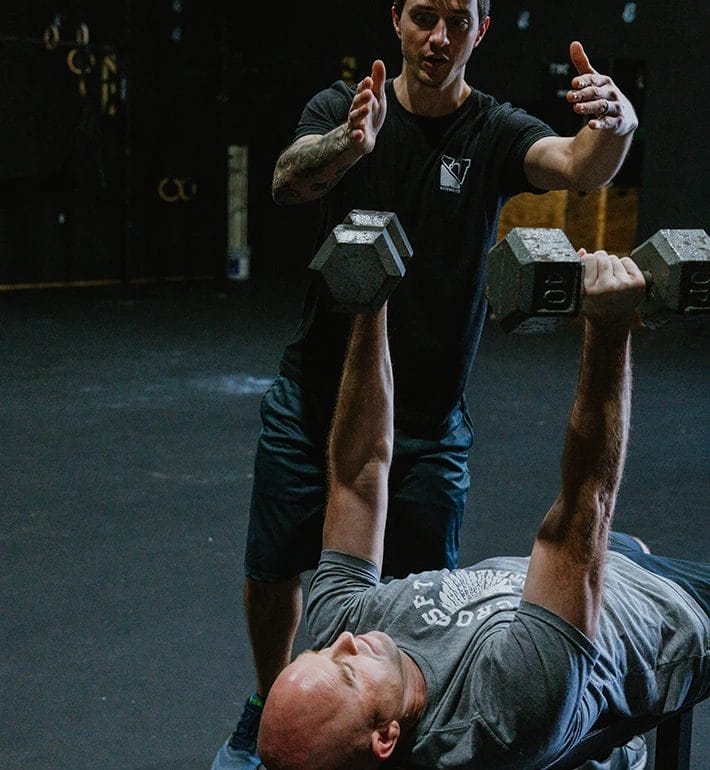 man doing bench press at WOTOWN FIT